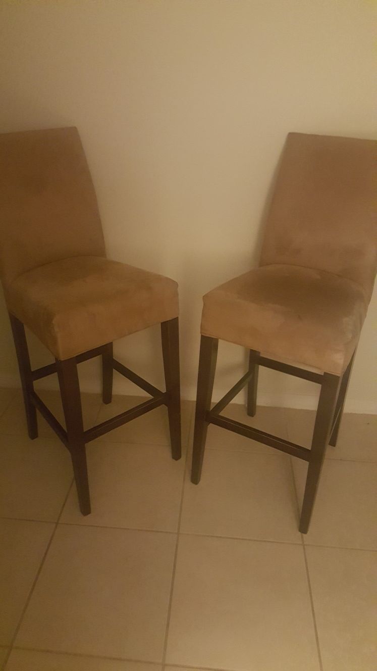 Two beige bar chairs