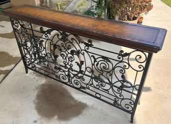 Ornate wrought iron console table.