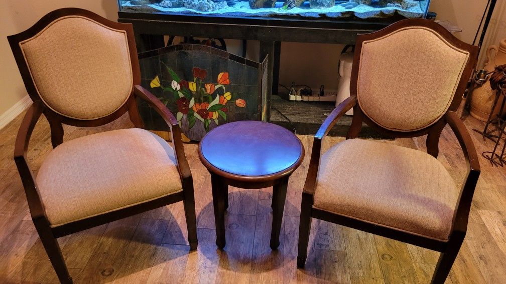 Two Wooden Chairs And Cocktail Table