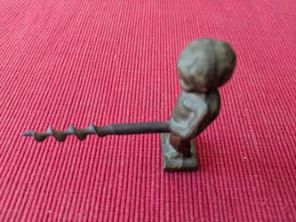 Vintage brass corkscrew is a bronze-colored metal figurine of the Manneken Pis