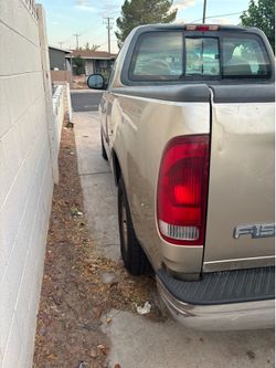 A tan Ford F150 truck