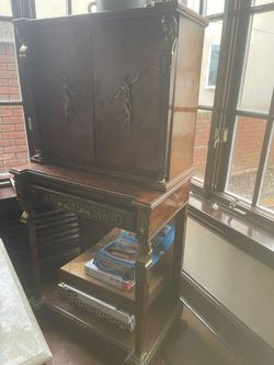 Antique tall storage caninet with claw feet and brass goddess detail