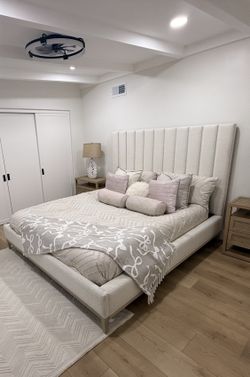 New Boucle upholstered king-sized platform bed.