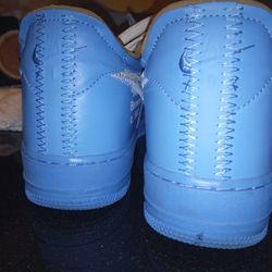 The product in the image is a pair of Nike Air Force 1 Low Off-White MCA sneakers in University Blue. 
