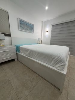 Like Brand new 4 months old Queen size bed with bottom storage and two night stands