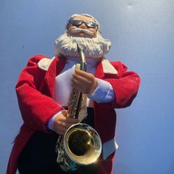 Battery power and saxophone playing Santa music plays & dances