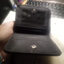 This item is slightly used. It's a brown cloth **UNISEX** ZIP-UP WALLET WITH ANOTHER POCKETED SECTION THAT HAS A SUPER CLICKY BUTTON!! **2CARD SLEEVES