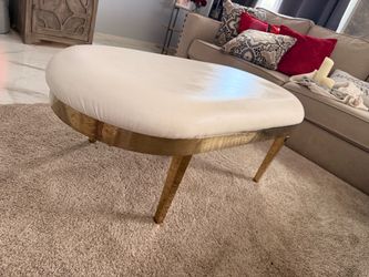 Oval Upholstered Ottoman with Gold Base