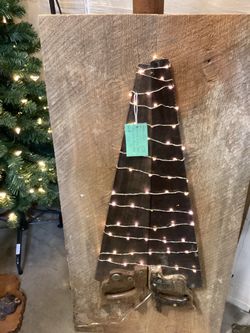 Lighted Christmas tree from saws mounted on Barnwood