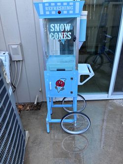a light blue Nostalgia 54-Inch Tall Snow Cone Cart,