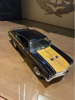 1:18 scale ERTL American Muscle 1971 Buick GSX die-cast model car in black and gold.