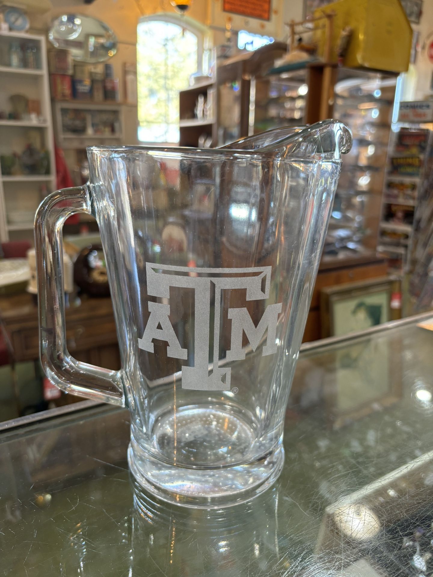 8x9 TEXAS A & M glass pitcher. 25.00.  Johanna at Antiques and More. Located at 316b Main Street Buda. Antiques vintage retro furniture collectibles m