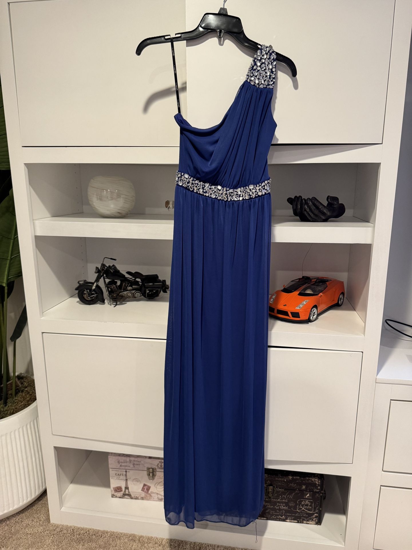 Royal blue long prom dress with silver rhinestones on the shoulders and waist. Brand new, size 5.