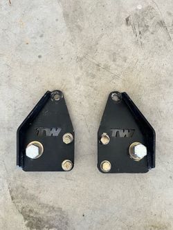 Shock relocation brackets