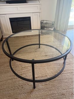 Clear glass circle coffee table with black trim