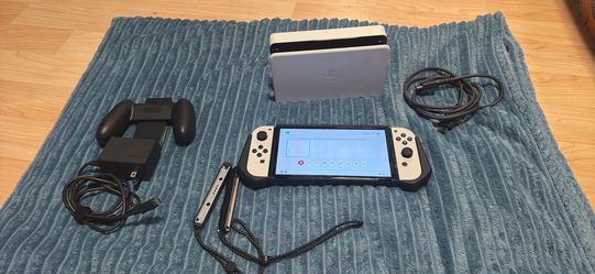 Nintendo switch oled with docking station, hdmi, Joycon grip, wrist straps and charger
