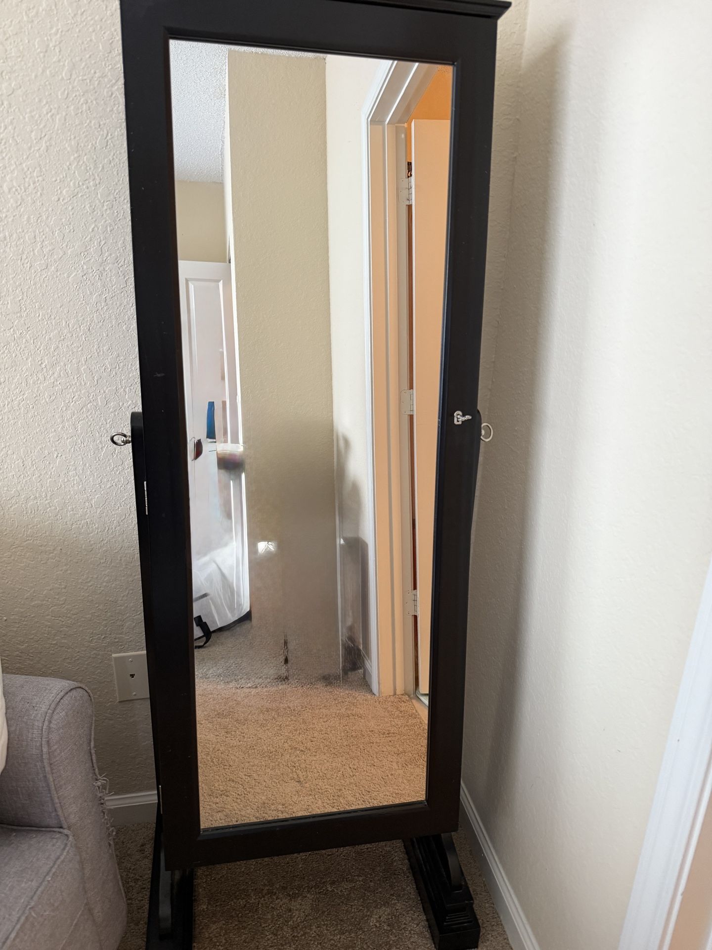 Jewelry armoire cabinet and full length mirror with velvet storage