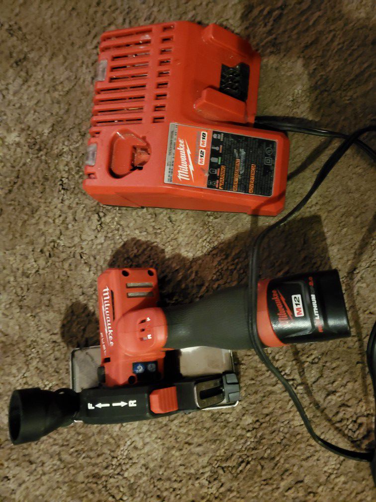 Milwaukee M12 cut off tool with a battery and charger