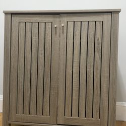 Storage cabinet with two doors slat style vented doors metal knob handle