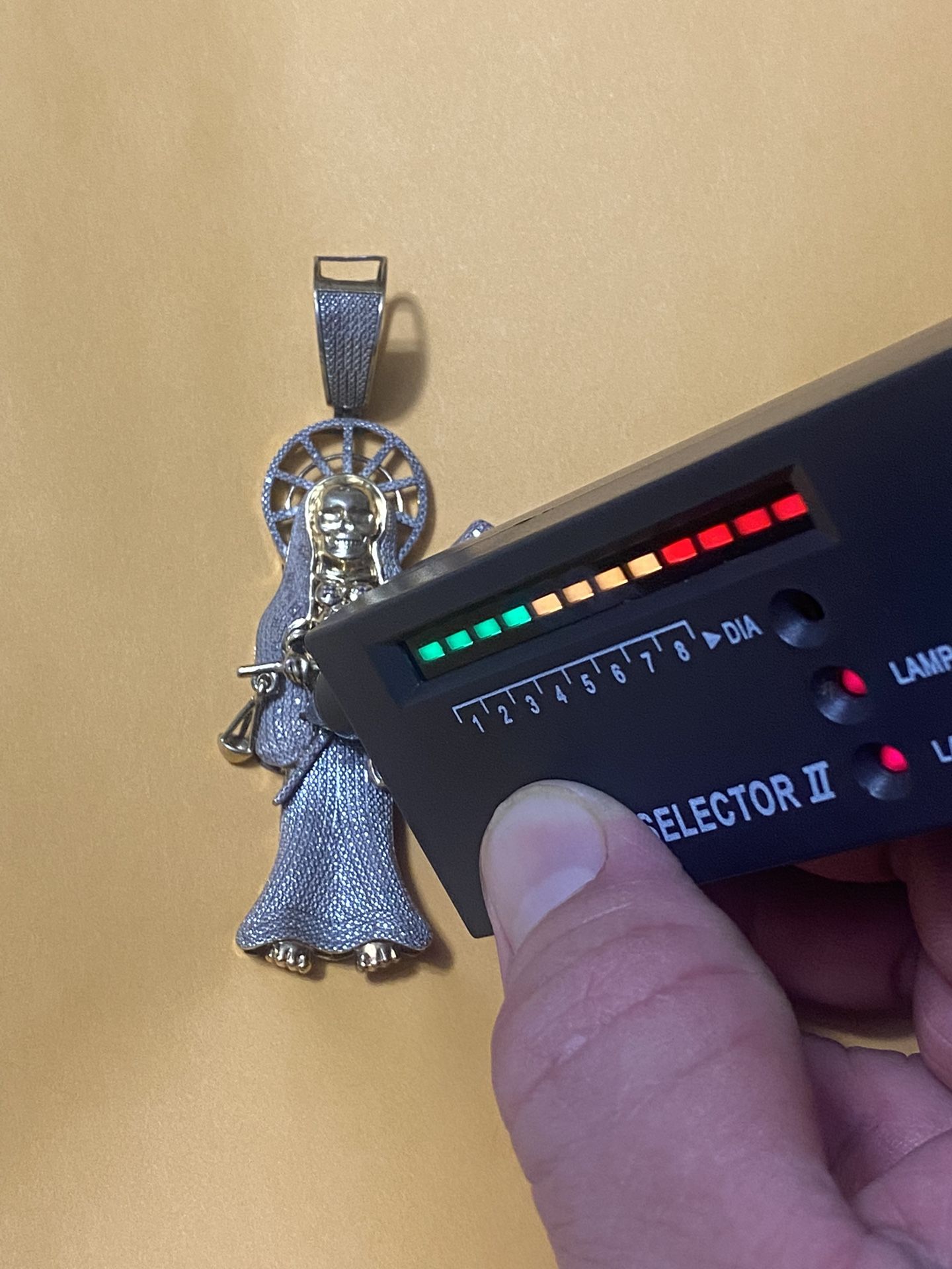The Santa Muerte made of silver plated with 14-carat gold and diamonds, the regular price is 680, I’m only asking for 280, firm price