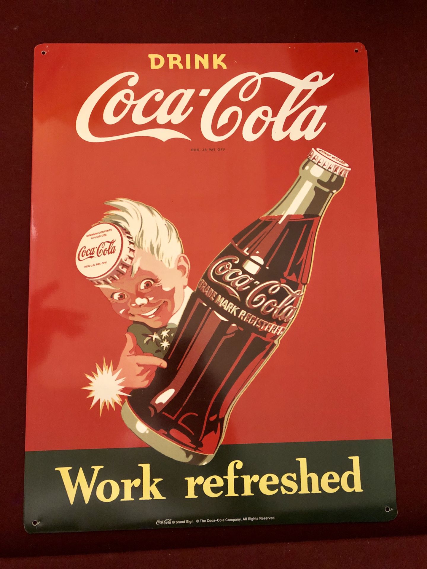 Metal Coca Cola sign. “Drink Coca-Cola Work refreshed”