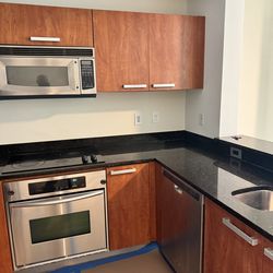 Kitchen with appliances wood drawers & cabinets dishwasher oven microwave high quality