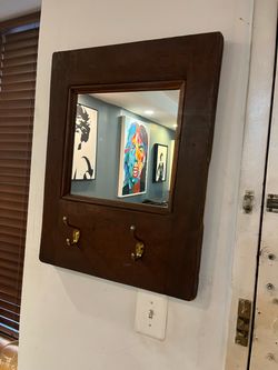 Wood framed wall mirror with hooks Wood framed wall mirror with hooks