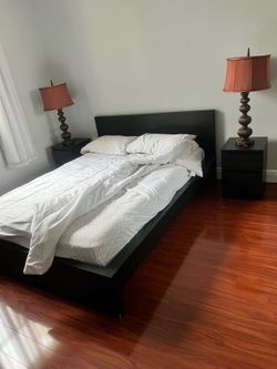 Full-size bed with mattress and nightstands