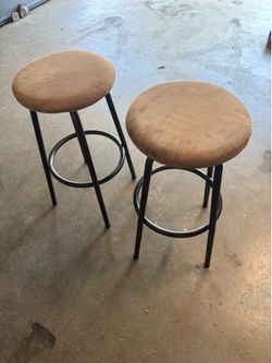 Two bar stools, padded suede and swivel