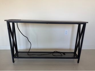Brown and black nightstand with built in power outlet