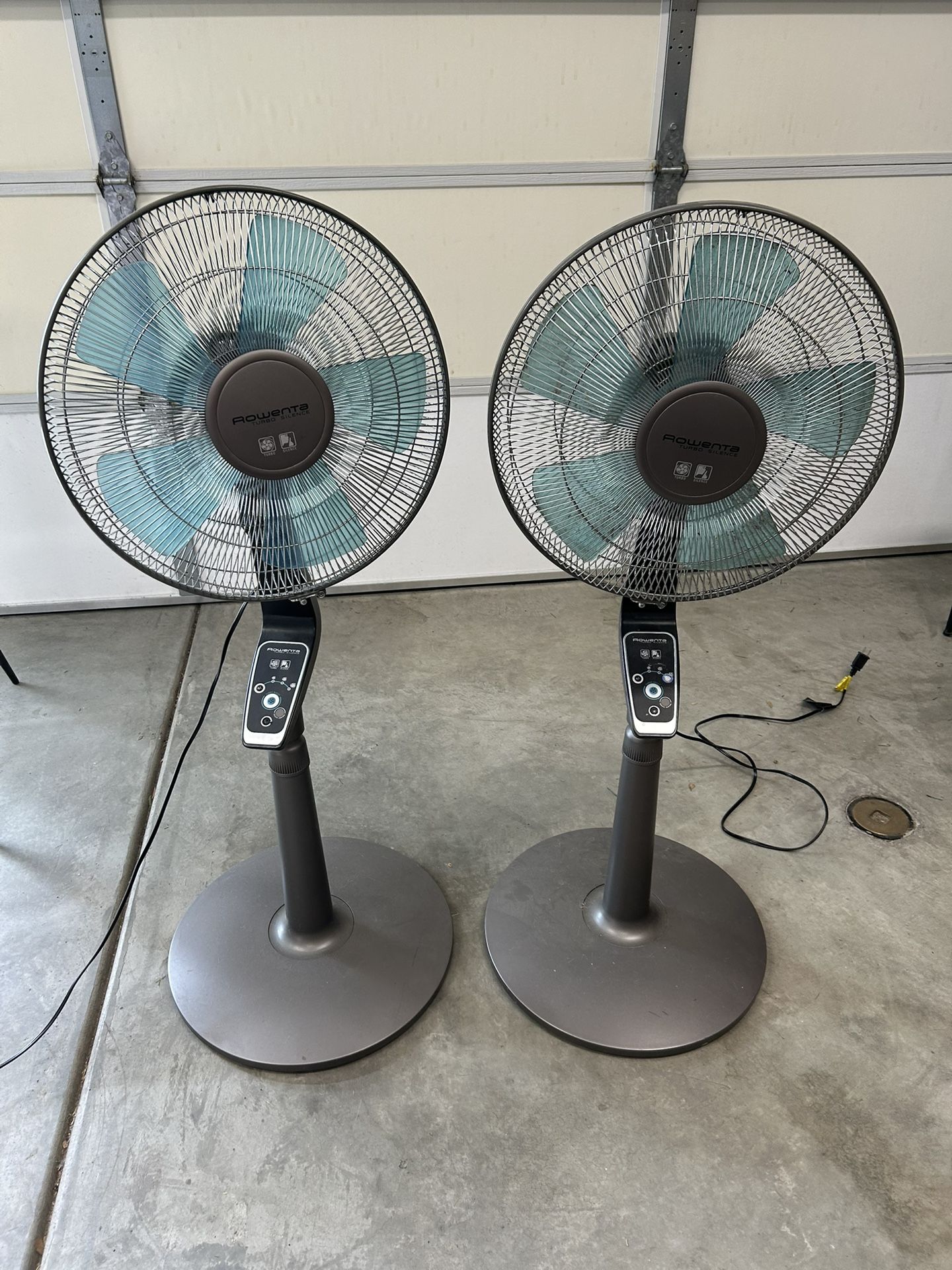 Tall, Blue And Gray Oscillating Fans. Both Work Well And Both Come With Remotes