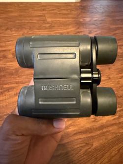 Bushnell binoculars—specifically a compact/folding style.