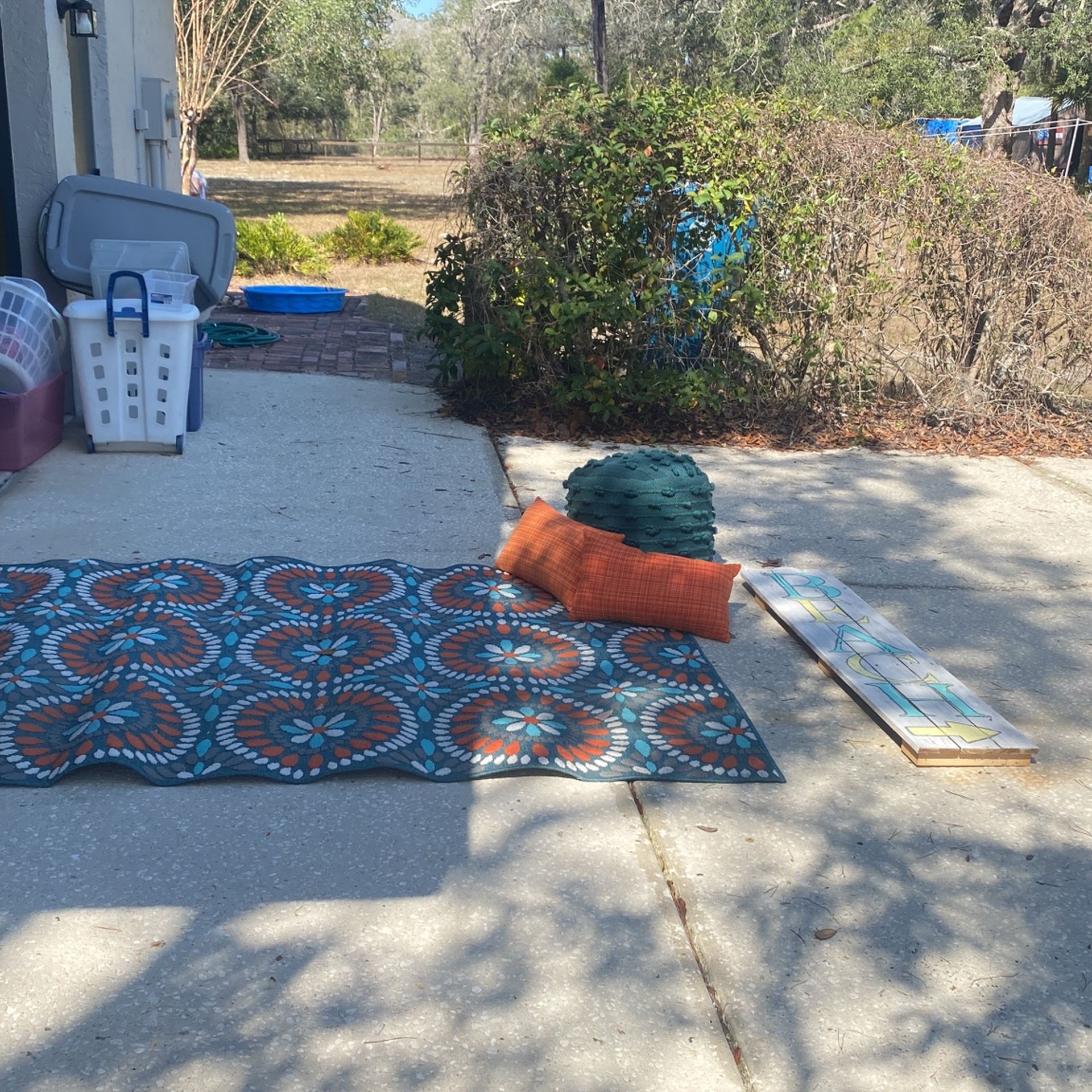 outdoor rug, ottoman, throw pillows, and beach sign set