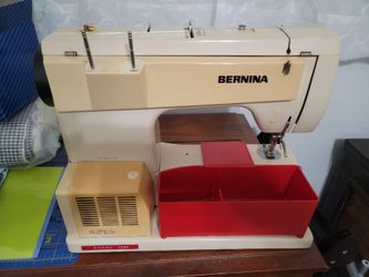 Bernina sewing machine with case and accessories. Sewing cabinet also available.