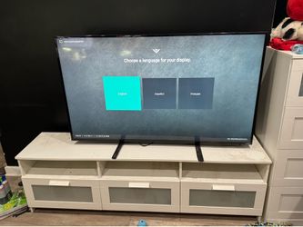 Vizio 60 inch smart tv with ikea white 6ft by 16 inch tv console with two  80 inch tall bookshelf’s