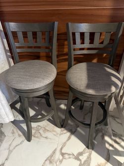 2 Grey swivel chairs