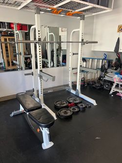 Squat rack, Olympic bar, and weights