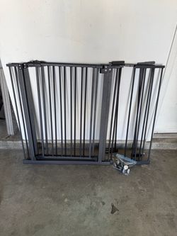 Two sets of black baby gates
