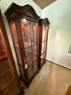 Elegant mahogany finish glass curio cabinet with internal lighting