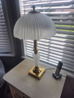 Vintage brass lamp with frosted glass shade and base.