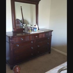 Queen bed, dresser with mirror and night stand but no mattress. Few scratches
