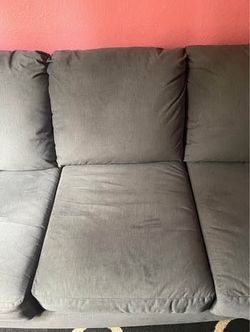 Gray couch folds up with king size bed