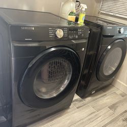brand new brushed black front load washer and dryer. stackable 
