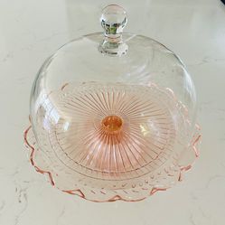 Pink glass pedestal cake plate w/ scalloped edge & glass cloche dome cover Cake plate is 3 1/4  tall x 11 3/4”  wide   Dome lid is 8” tall x 10 1/2” w