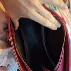 A Pink Purse That Has Some Kind Of Fur In Front Of It 