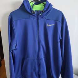 Nike Therma-FIT full-zip hoodie in blue with a lime green inner lining. 