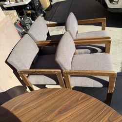 Two Tables On Stands And Chairs With Wheels