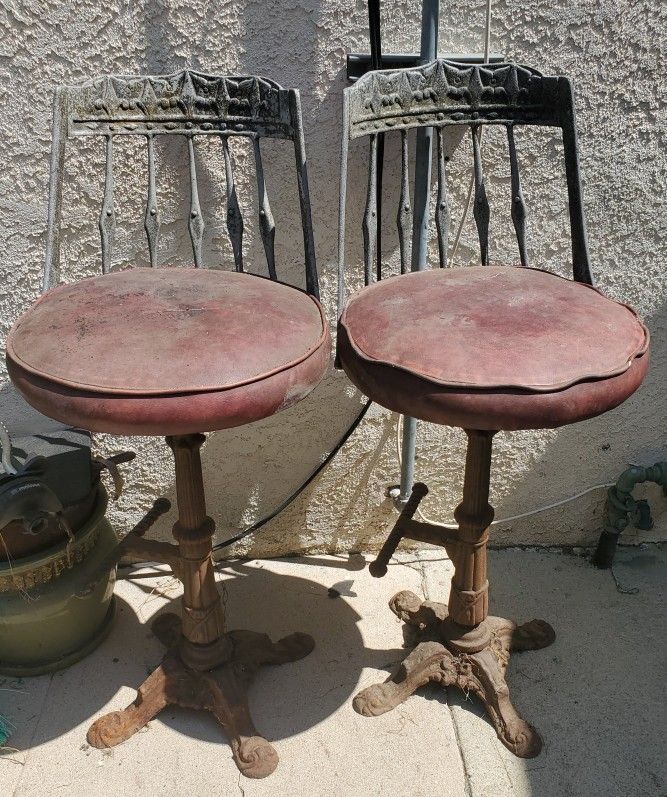 2 VINTAGE CAST IRON BAR STOOLS $50