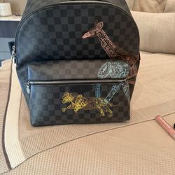 2022 The backpack in the image is a Louis Vuitton Discovery Backpack PM from the Damier Graphite Stamps limited edition collection.