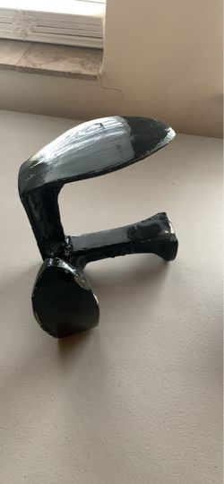 Traditional cast iron cobbler's anvil, which is a classic tool used for shoe and boot repair.